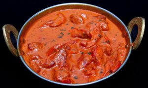 Creamy butter chicken curry garnished with fresh cilantro