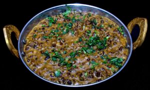 Creamy dal makhani made with black lentils and kidney beans simmered in buttery tomato gravy