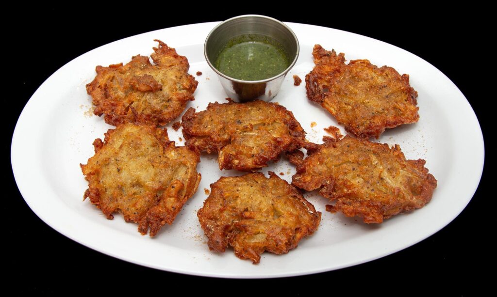 Crispy onion pakora fritters served with chutney at Indian Bites in Lyons, Boulder, and Estes Park