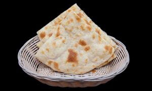 Freshly baked flatbread plain naan served warm from the tandoor at Indian Bites in Lyons, Boulder, Longmont, and Estes Park