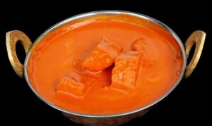 Spiced tofu cubes cooked in rich Indian masala gravy with tomatoes and onions