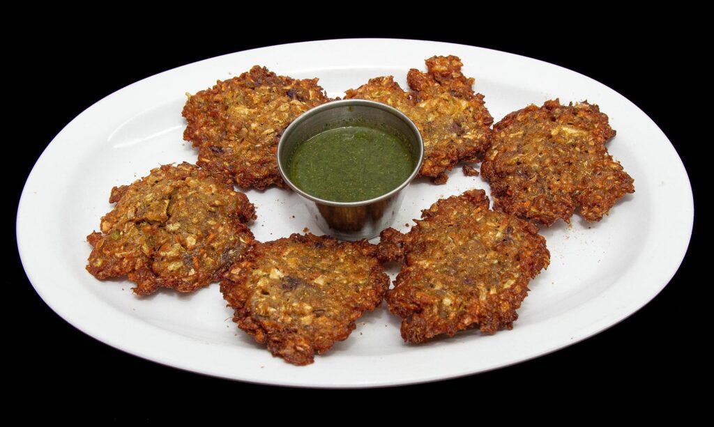 Crispy vegetable pakora fritters served with chutney at Indian Bites in Lyons, Boulder, Longmont, and Estes Park