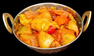 Chicken simmered in a spicy tomato-based karahi sauce with onions and peppers – Indian Bites in Lyons