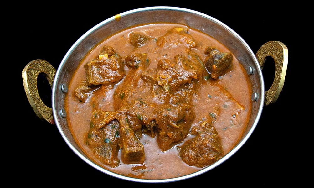 Tender goat meat cooked in traditional Indian spiced curry gravy