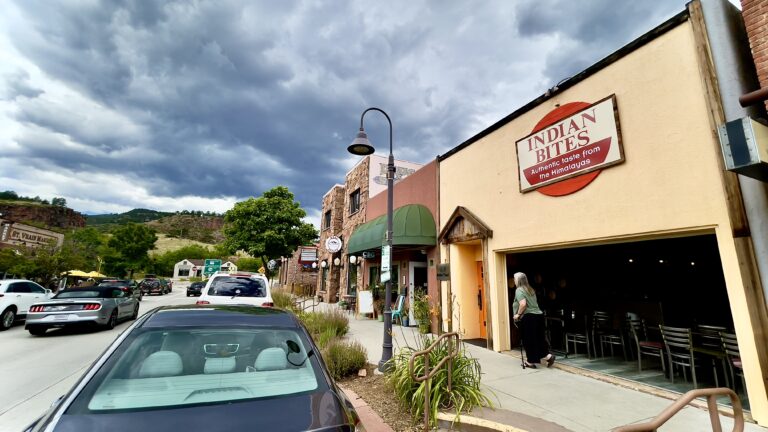 Indian Bites restaurant exterior in Lyons, Colorado with Rocky Mountain backdrop near Planet Bluegrass