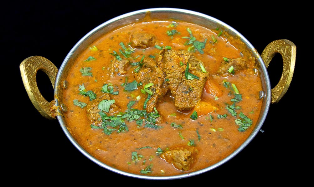 Tender lamb pieces cooked in traditional Indian spiced curry gravy