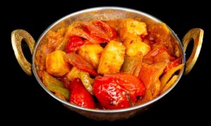 Paneer cubes in spicy tomato-based karahi sauce with bell peppers and onions – Indian Bites in Lyons