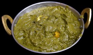 Juicy shrimp cooked in creamy spinach saag gravy with aromatic Indian spices