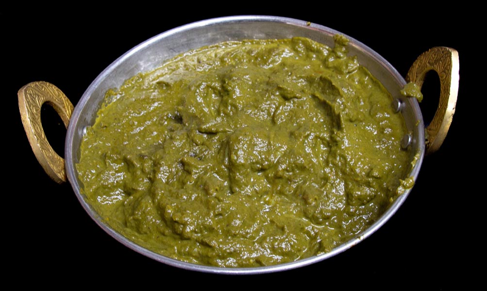 Soft tofu cubes cooked with creamy spinach and aromatic spices in a vegan curry