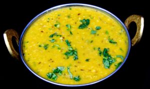 Small serving of yellow lentils cooked with spices and tempered with mustard seeds and garlic