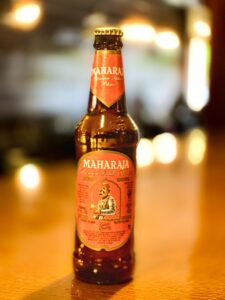 Maharaja Beer bottle with royal-inspired design, showcasing a smooth and bold golden lager brewed for kings and enjoyed in Lyons, Estes Park, Longmont, Boulder, Loveland, and nearby Colorado cities.