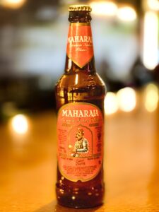 Maharaja Beer bottle with royal-inspired design, showcasing a smooth and bold golden lager brewed for kings and enjoyed in Lyons, Estes Park, Longmont, Boulder, Loveland, and nearby Colorado cities.