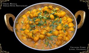 Close-up of Chana Masala in a white bowl, showing chickpeas in spiced tomato gravy, garnished with fresh cilantro — authentic Indian cuisine at Indian Bites Lyons, Lyons, Colorado.