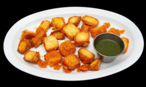 Crispy paneer pakora made with Indian cottage cheese, chickpea flour, herbs, and spices at Indian Bites.