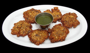 Crispy vegetable pakora made with fresh vegetables, chickpea flour, herbs, and spices at Indian Bites.